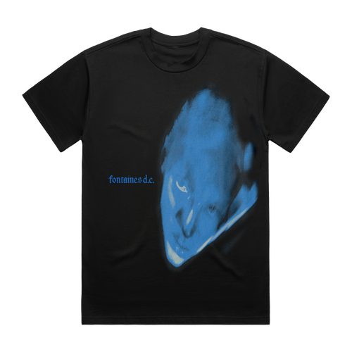 A black short-sleeve t-shirt featuring a large blue graphic print of a distorted face on the front, with the text 'fontaines d.c.'
