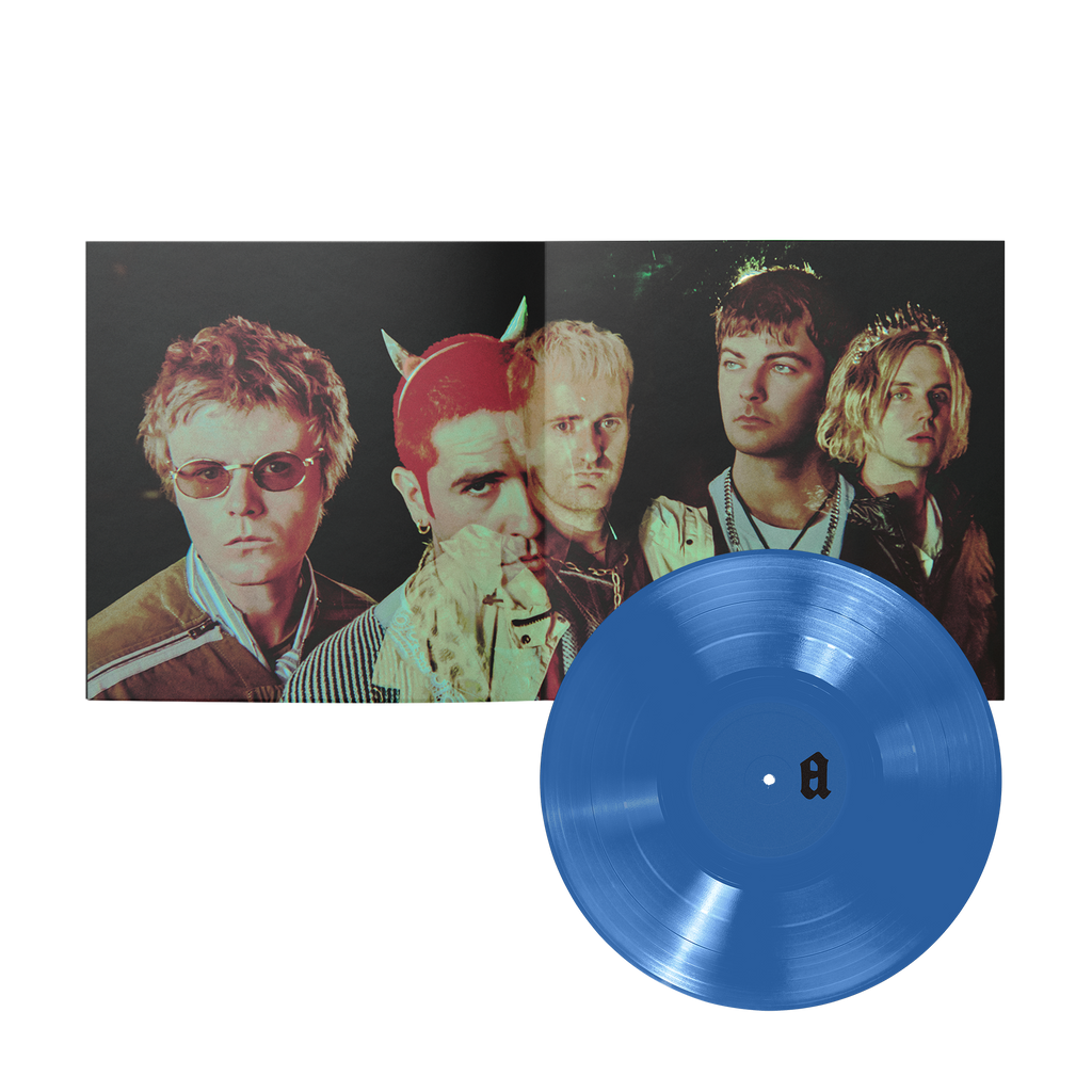 A blue vinyl record in front of an open music album with a band portrait on the cover.
