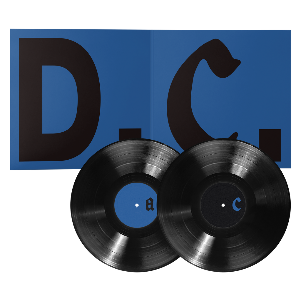 Two black vinyl records displayed in front of an open blue "D.C." insert. 