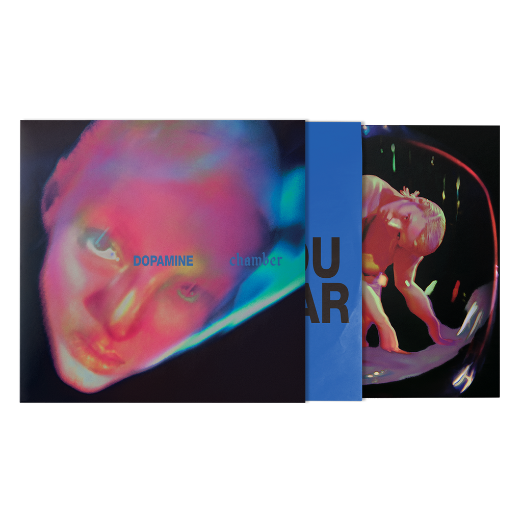 A vinyl record sleeve and inner sleeve. The artwork features a distorted, neon-toned close-up face, with a blue vertical band and dark text.