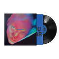 A vinyl record partially pulled from its sleeve, showing a black LP with a blue center label and a colorful album cover.